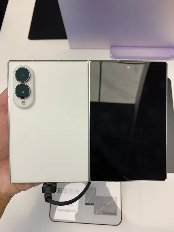 Rear of a Samsung Galaxy Z Fold8 in white, unfolded flat on a display stand