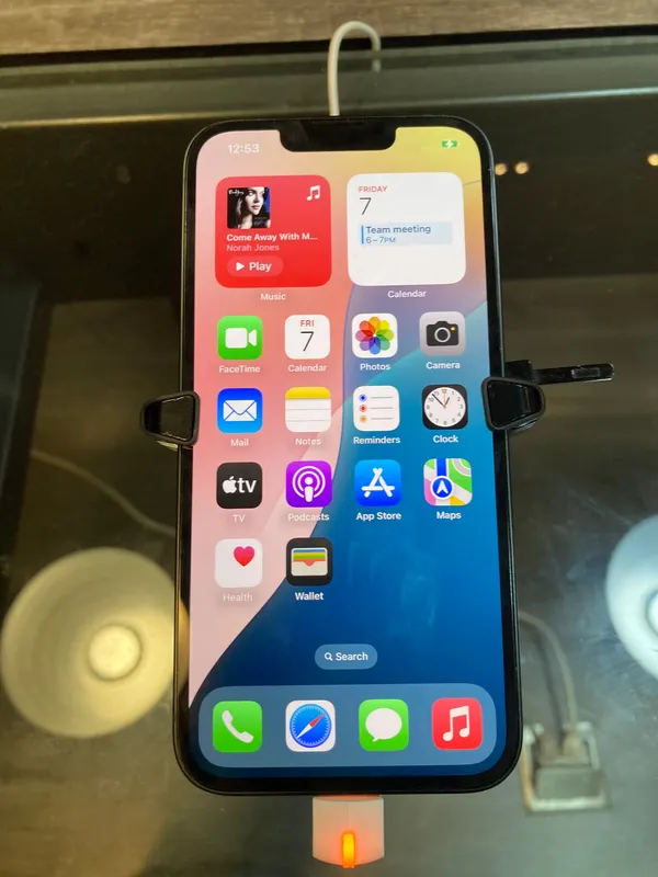 Apple iPhone 16e in black, front view on a display stand