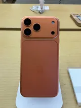 Apple iPhone 17 Pro Max in cosmic orange, rear view on a display stand