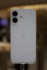 Apple iPhone 17 in white, rear view on a display stand